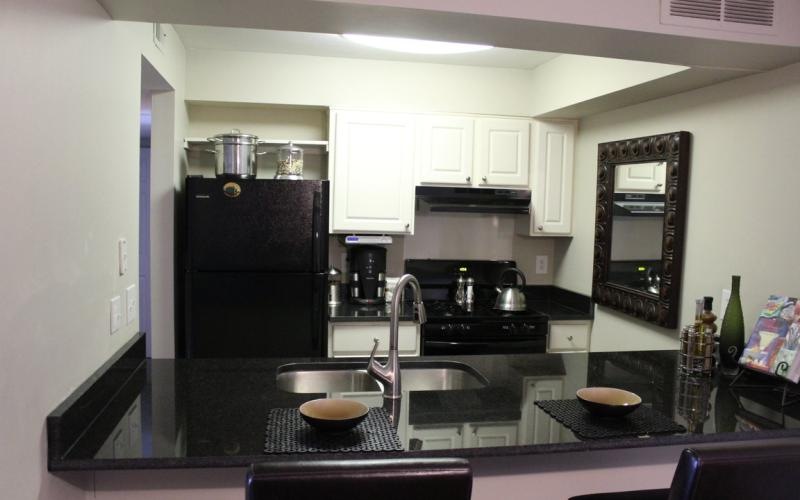 a kitchen with black appliances
