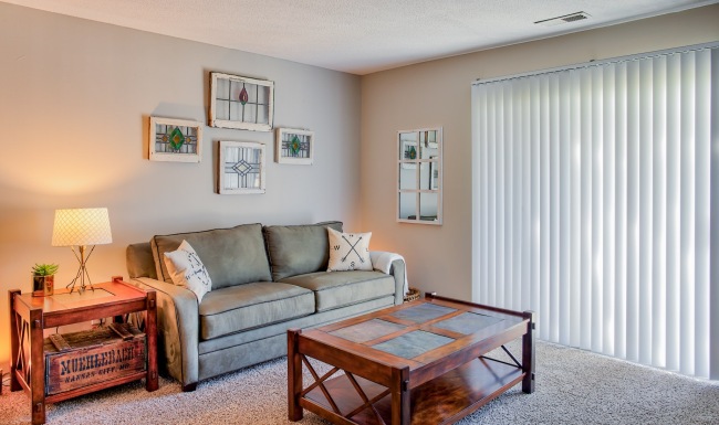 Upgraded Nora Far Northside apartments Styled living room with blinds